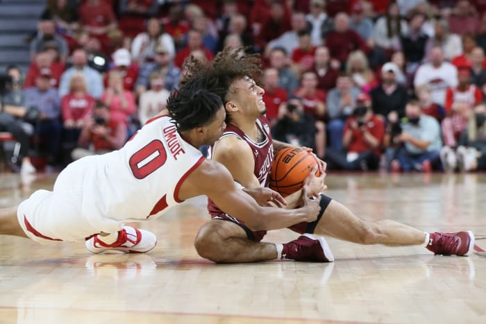South Carolina Gamecocks guard Devin Carter (23) and Arkansas Razorbacks guard Stanley Umude (0) reach for a loose ball in the first half at Bud Walton Arena.